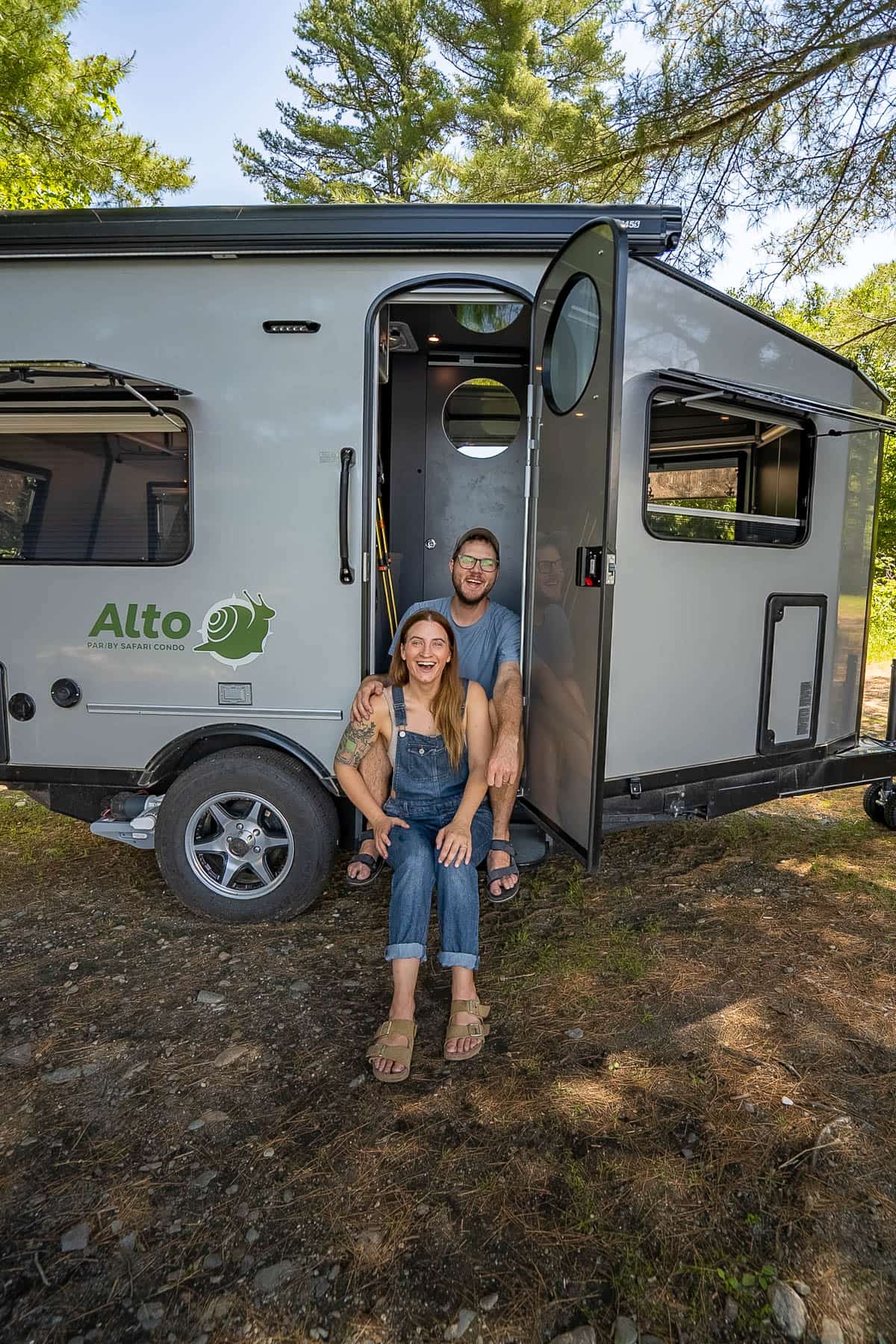 Couple sitting in a Safari Condo Alto F1752 travel trailer in Maine