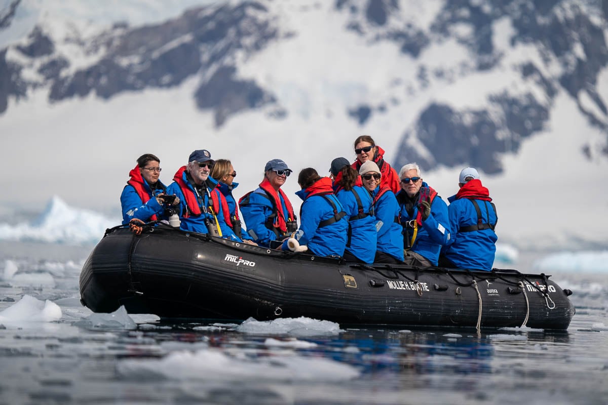 Passengers on a Zodiac cruise with Aurora Expeditions at Chiriguano Bay in Antarctica