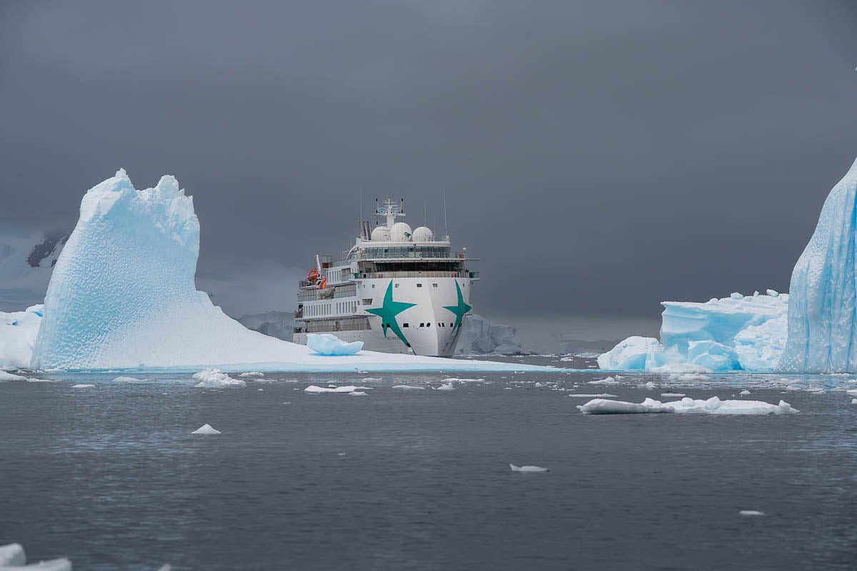 Aurora Expeditions Greg Mortimer surrounded by icebergs at Wilhelmina Bay in Antarctica