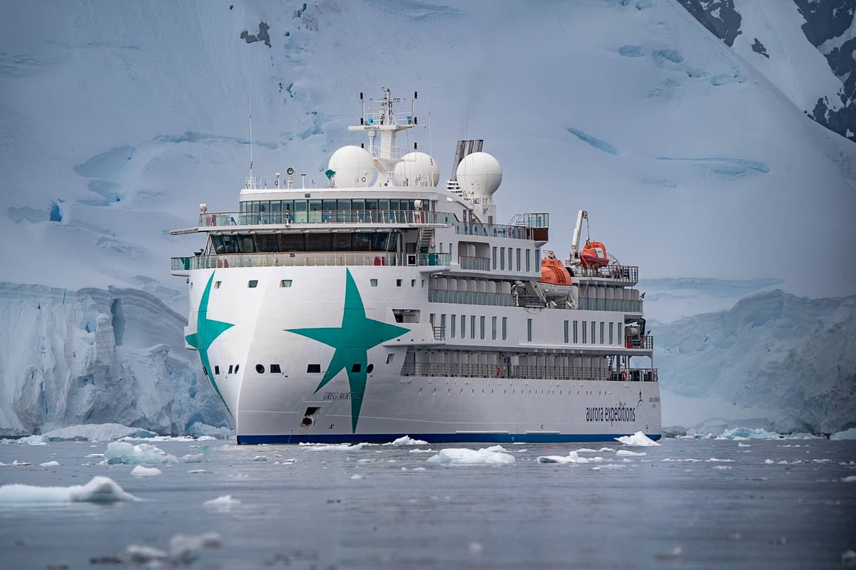 Aurora Expeditions Greg Mortimer with glaciers in the background in Antarctica