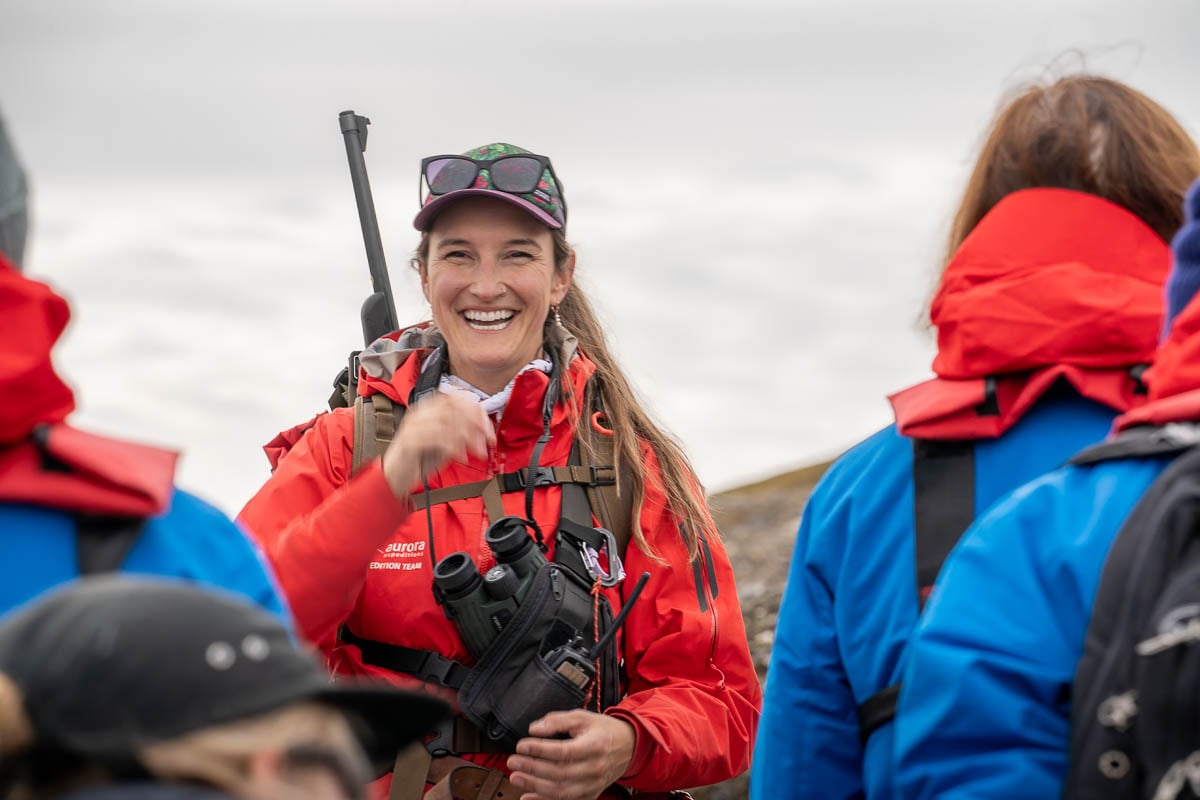 Aurora Expeditions guide smiling at guests in Svalbard, Norway