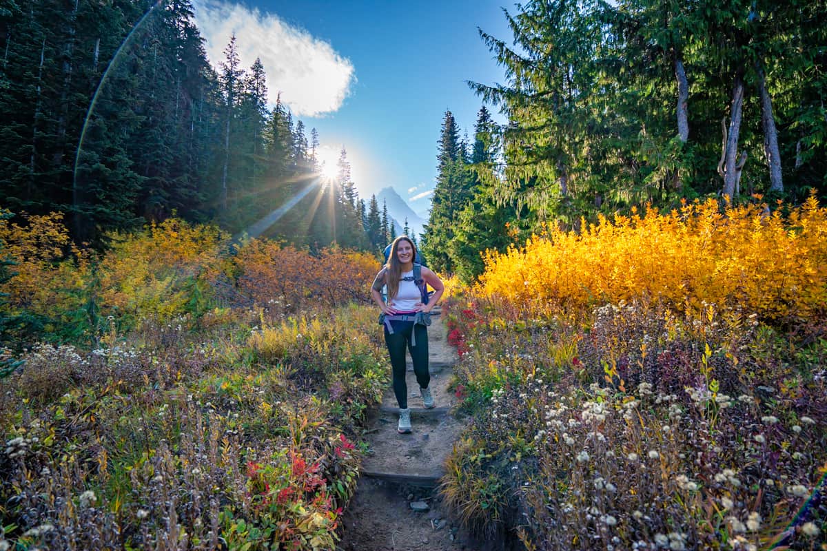 Woman walking through fall wildflowers along the Summerland Trail in Mount Rainer National Park