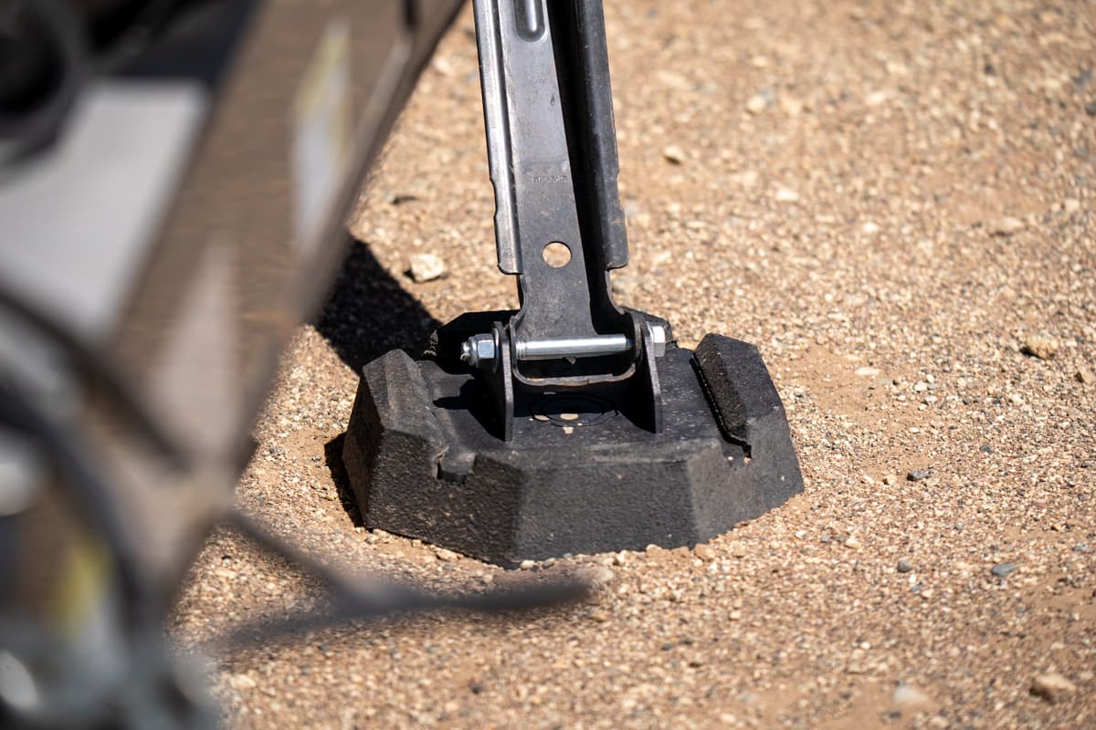 Rubber RV stabilizing jack pad on a Safari Condo Alto A1752 resting on a sandy surface
