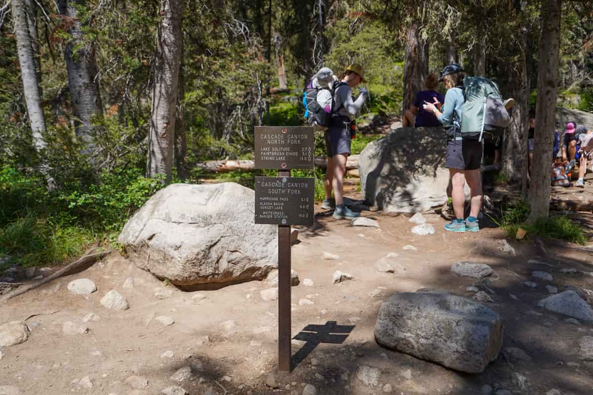 Trail signs for Cascade Canyon North and Cascade Canyon South Fork Trails at the end of the Cascade Canyon Trail in Grand Teton National Park in Wyoming