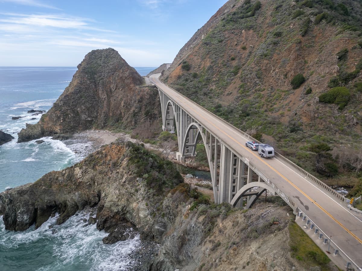 SUV towing a trailer down a bridge along the Pacific Coast Highway in California