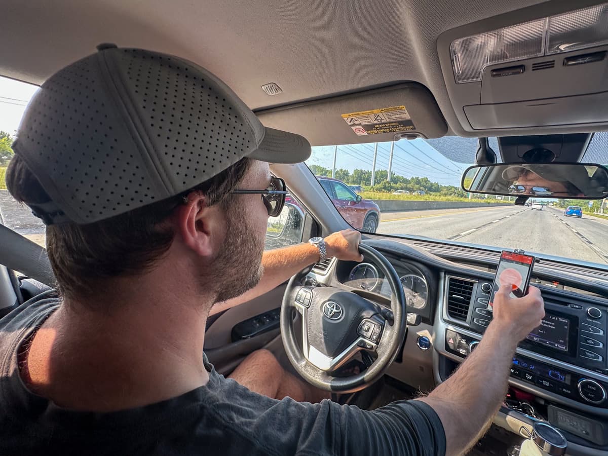 Man driving and pressing the OneControl Auto app for the Curt Echo Wireless Brake Controller