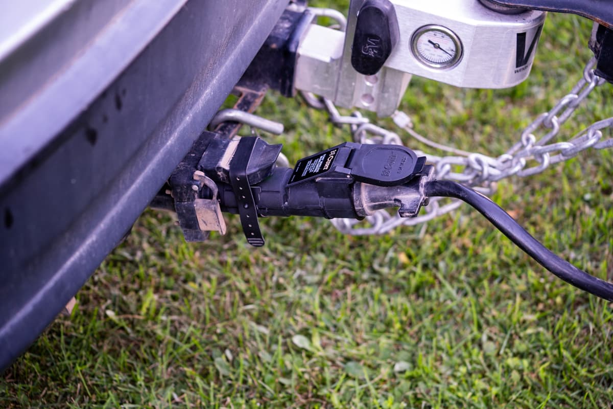 Seven pin connector of a trailer plugged into a Curt Echo wireless brake controller on the back of a vehicle