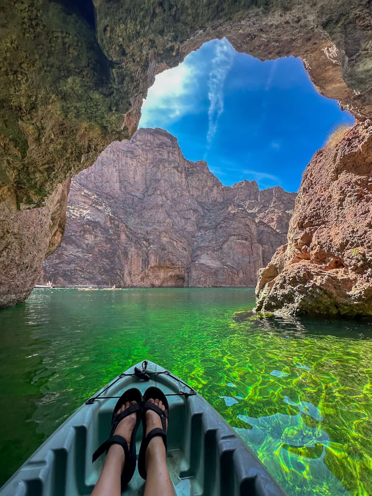 Front of a kayak with a woman's feet in the Emerald Cave in Lake Mead National Recreation Area in Willow, Arizona