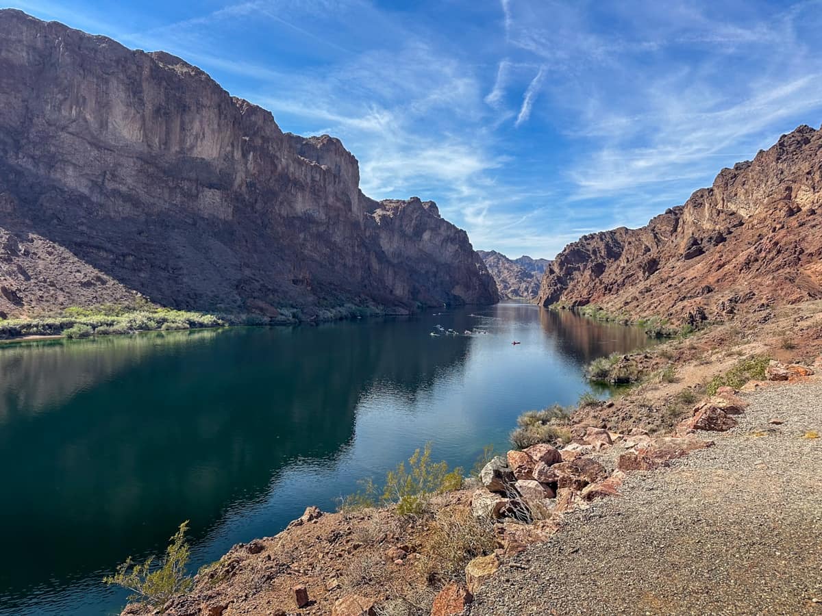 Overlook of the Colorado River with kayakers and red canyon walls in the Lake Mead National Recreation Area in Willow Creek, Arizona
