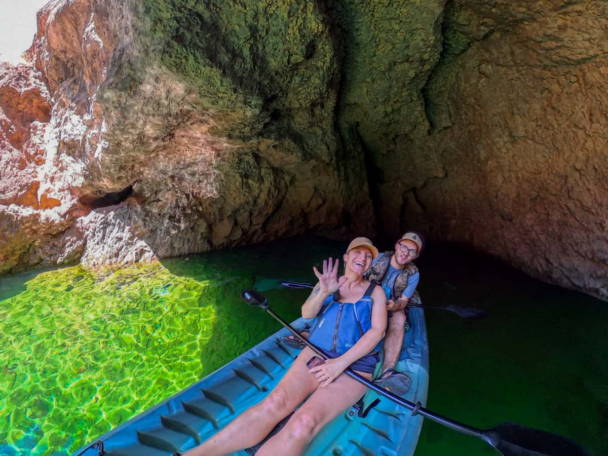 Couple sitting in a kayak in the Emerald Cave in Lake Mead National Recreation Area in Willow, Arizona