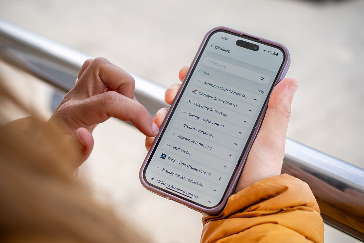 Woman looking at a cellphone with different GigSky eSIM plans for cruiselines