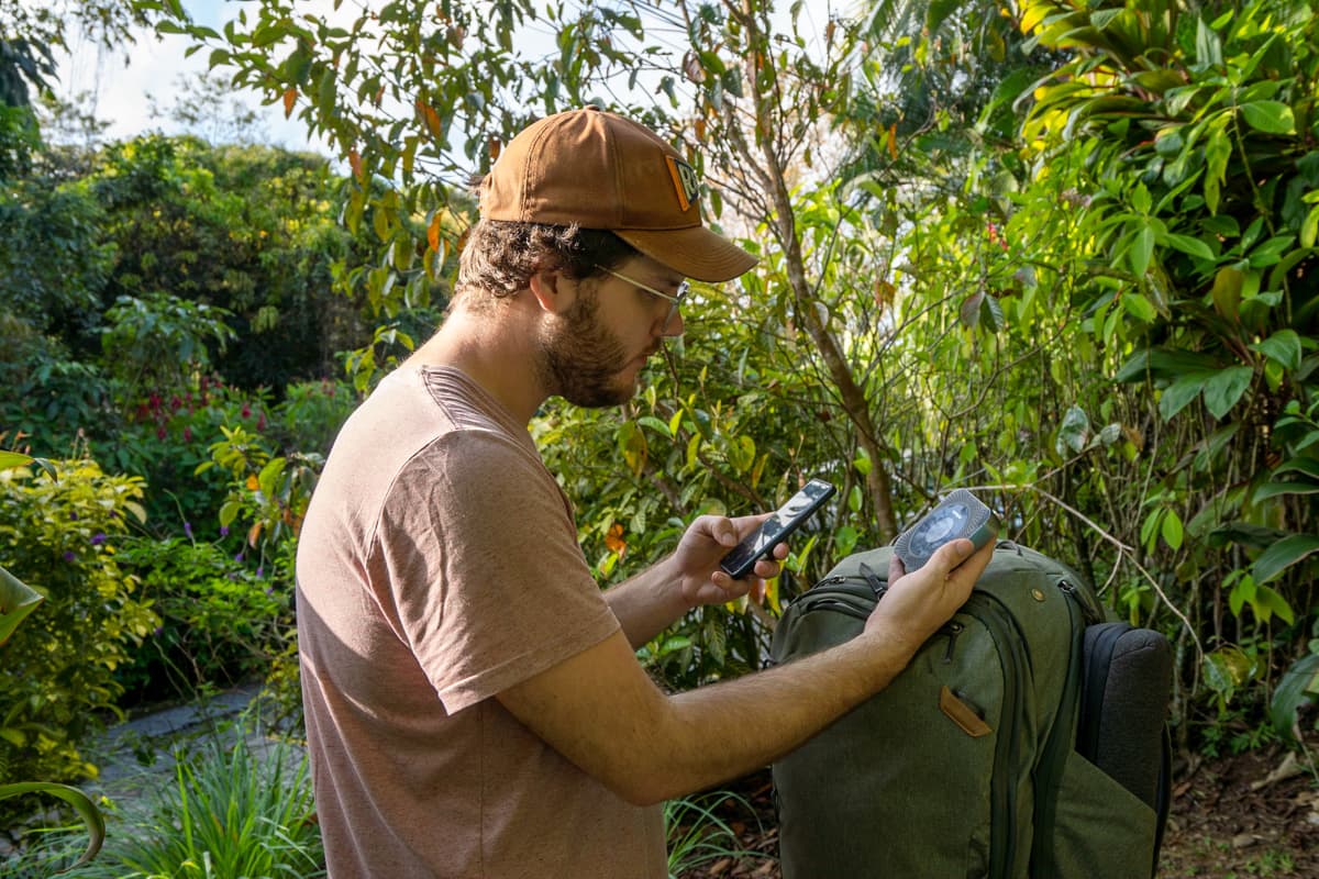 Man looking at a wireless router and his cell phone in Costa Rica