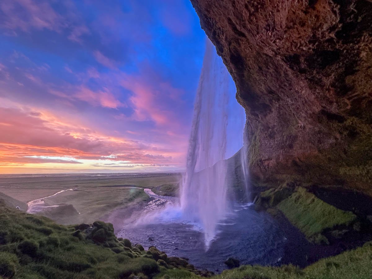 Waterfall cascading down a cliffside at Seljalandsfoss in Iceland