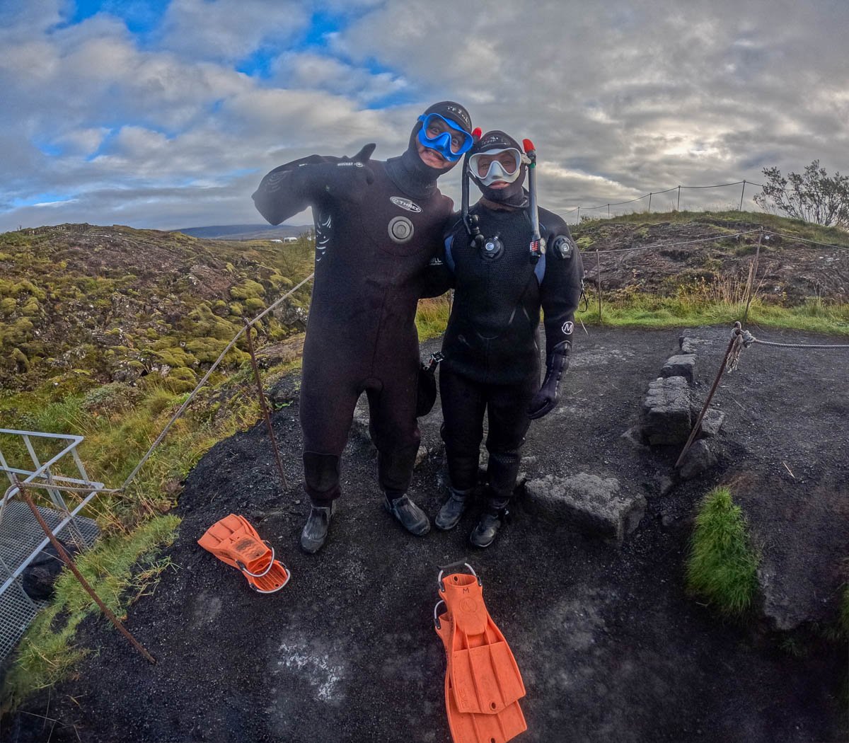 Couple wearing drysuits before getting in Silfra at Thingvellir National Park in Iceland