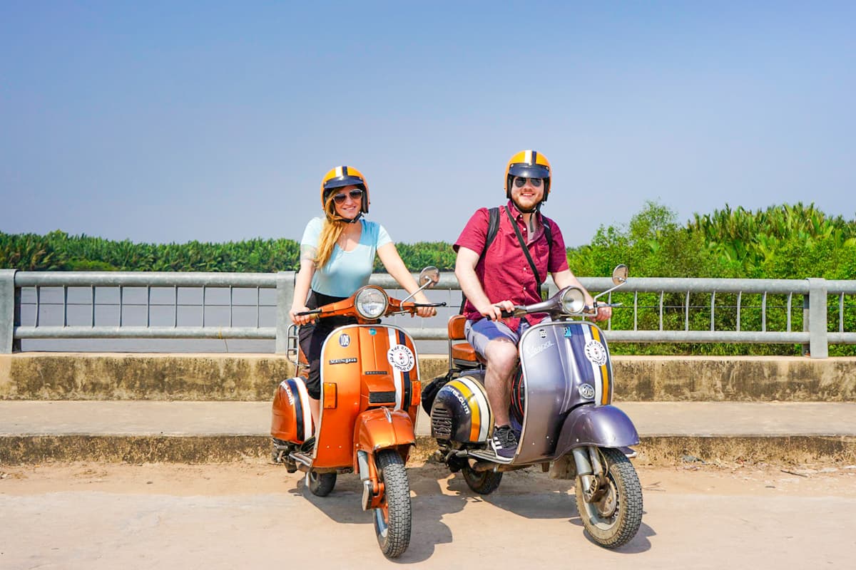 Couple sitting on motorbikes in the Mekong Delta of Vietnam