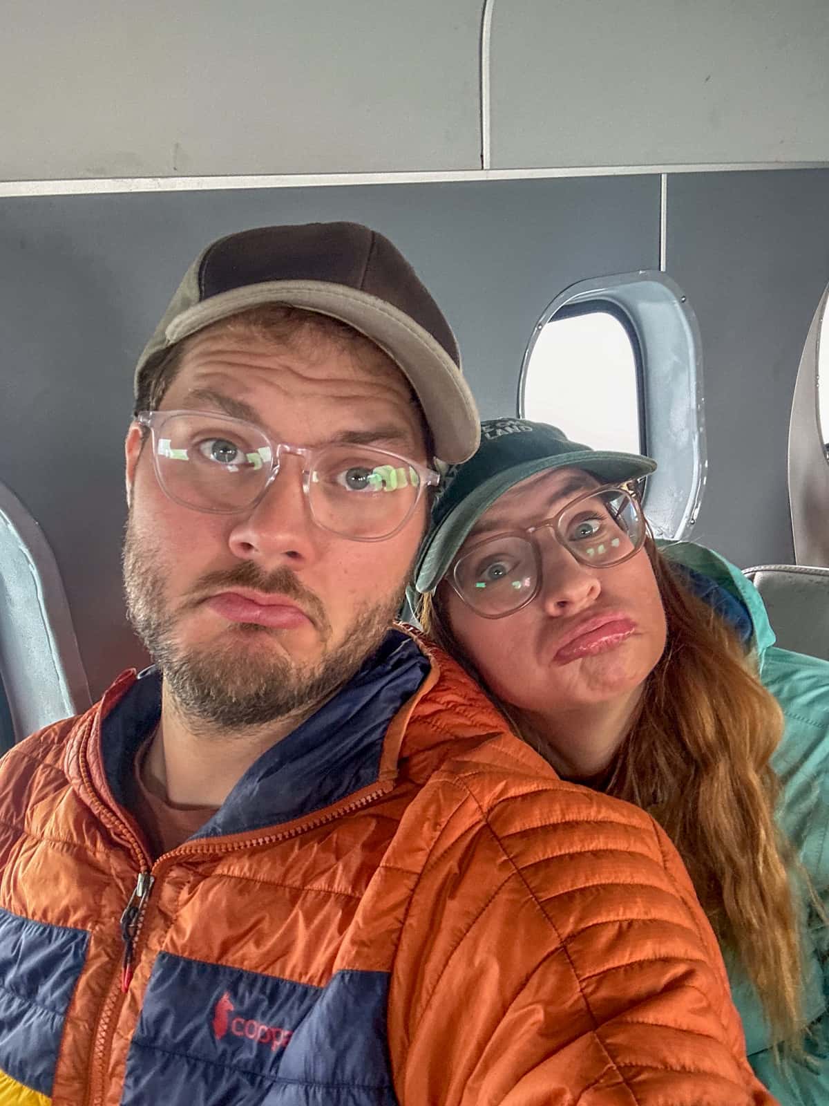 Frowning couple sitting in a seaplane leaving Katmai National Park in Alaska