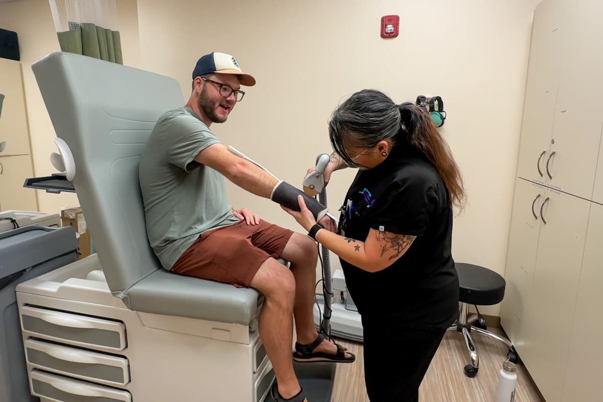 Man getting his cast cut off his arm at a medical clinic