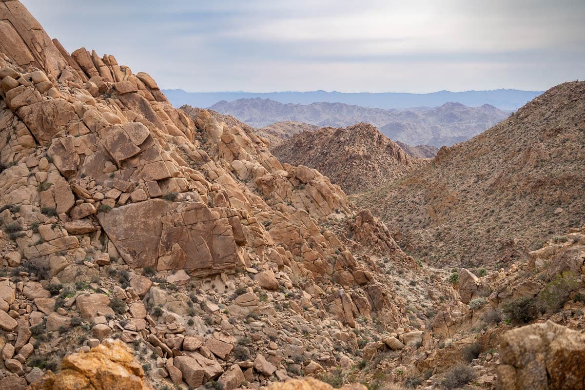 Monzogranite boulders along mountain slopes on the Lost Palms Oasis Trail in Joshua Tree National Park, California