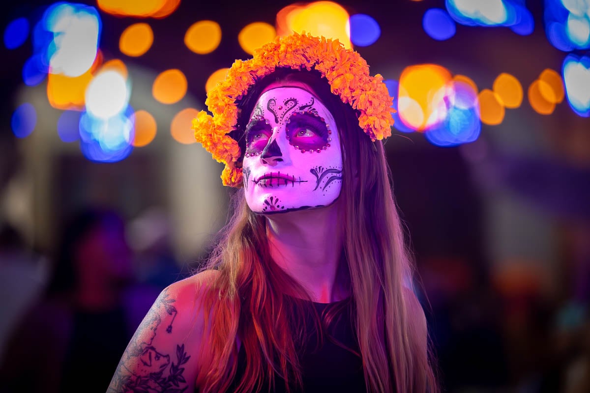 Woman wearing Calavera Catrina makeup and a marigold crown for Day of the Dead in Oaxaca, Mexico