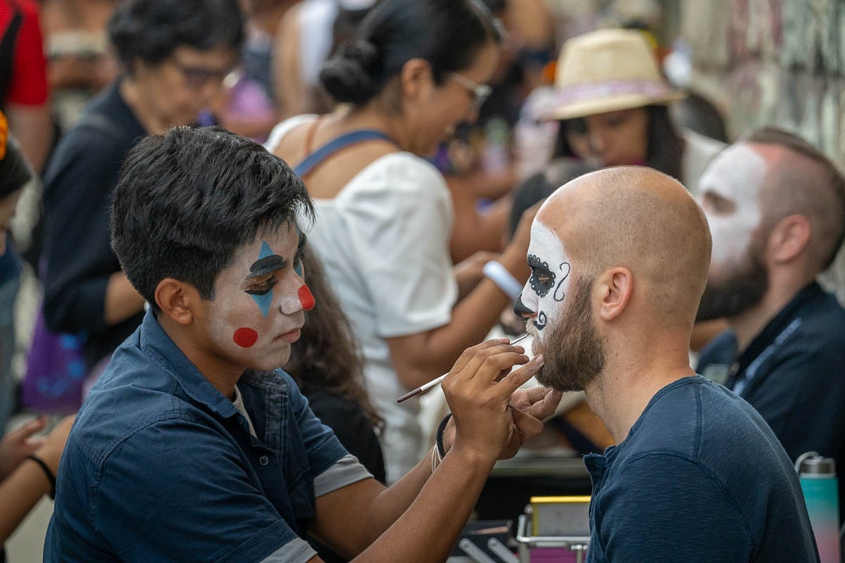Man getting Calavera Catrina makeup done for Dia de Muertos in Oaxaca, Mexico