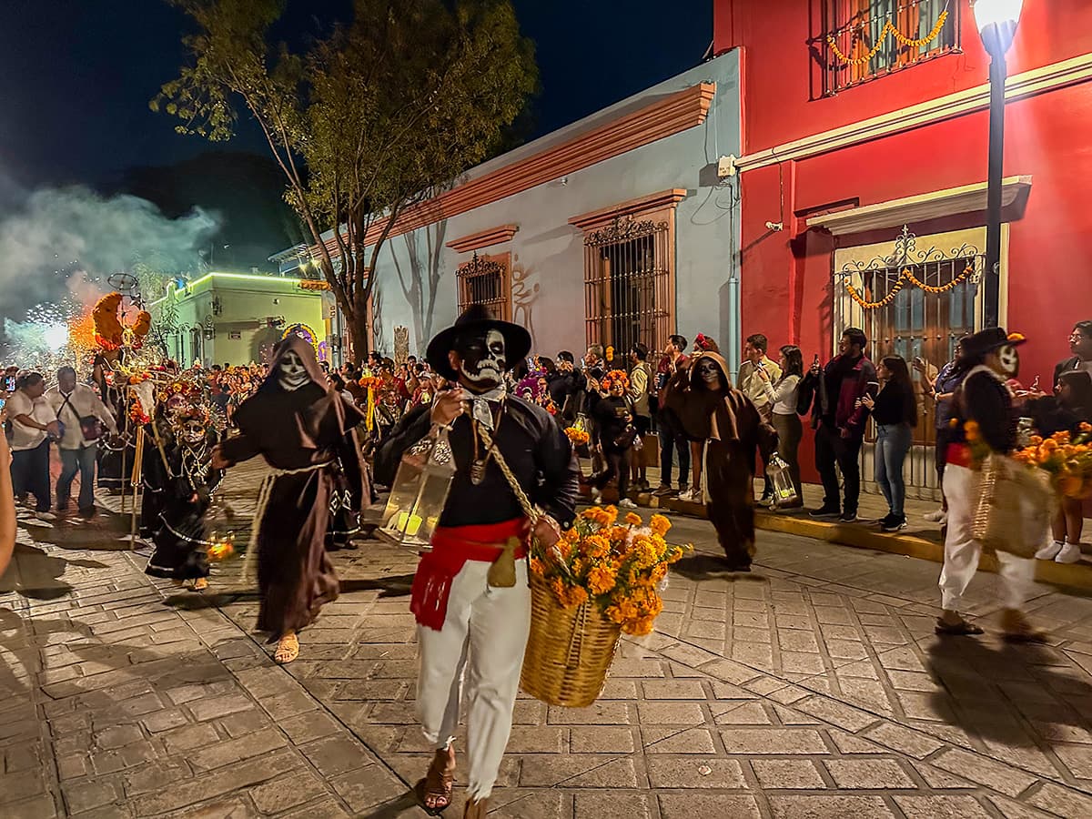 People with Calavera Catrina makeup and costumes marching in Day of the Dead parade in Oaxaca, Mexico