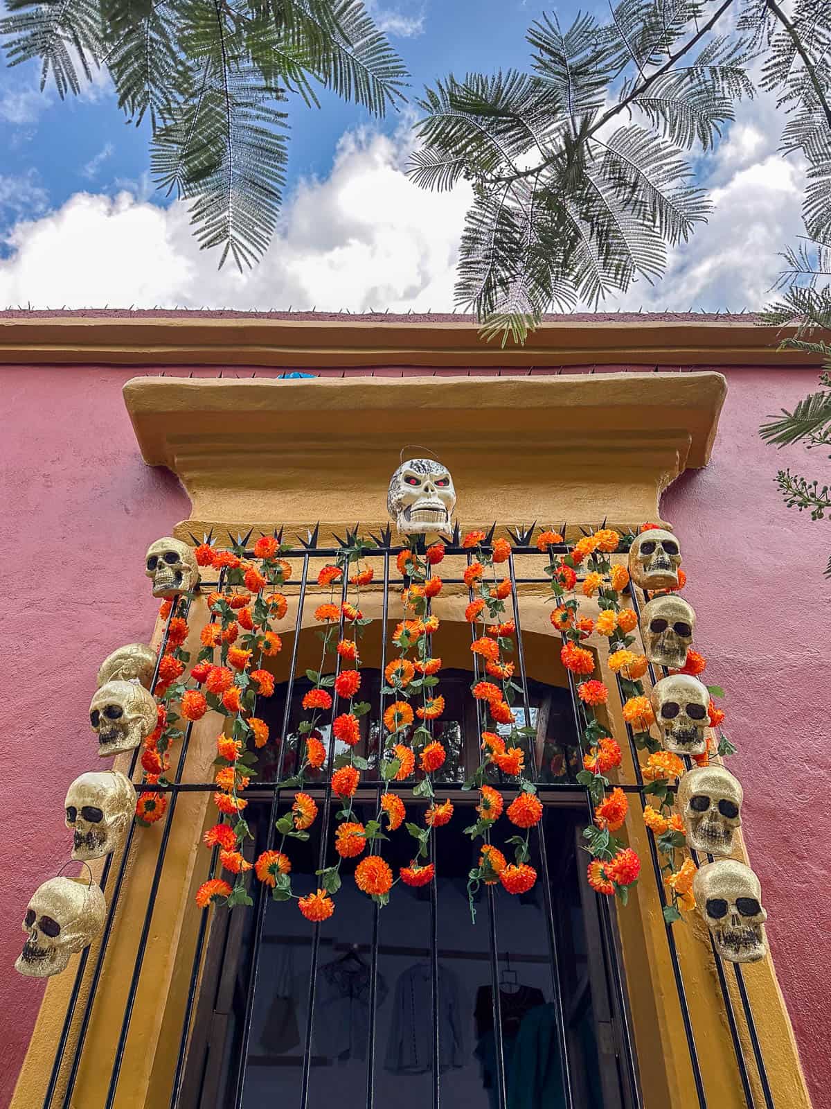 Window decorated with marigolds and skulls for Day of the Dead in Oaxaca, Mexico