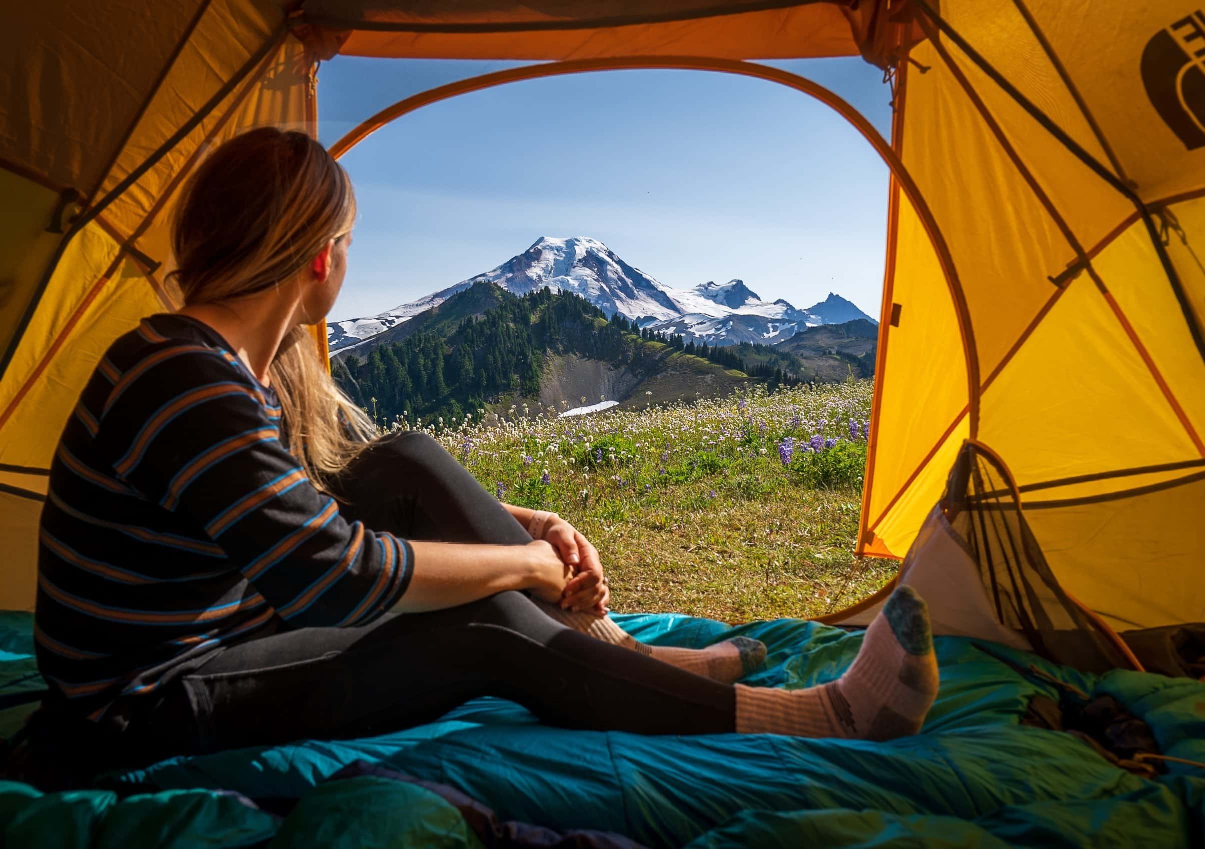Woman sitting in a tent along the Skyline Divide trail