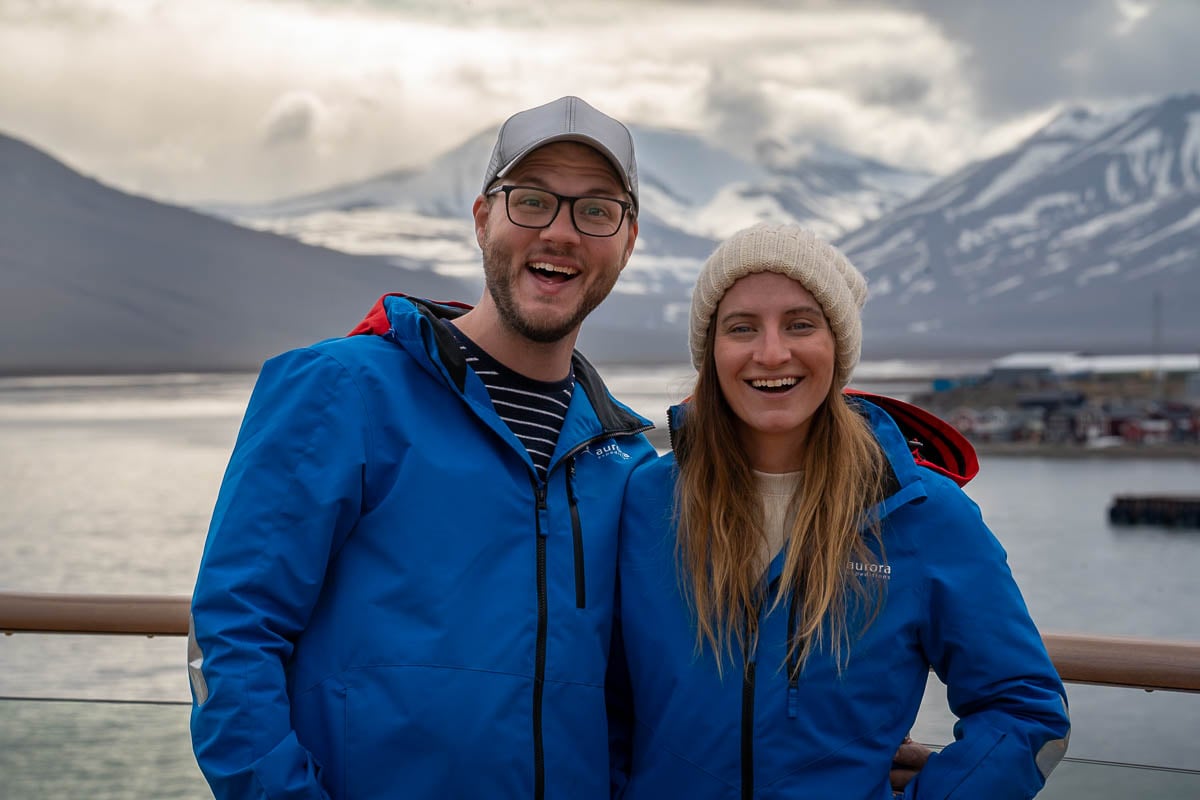 Couple wearing Aurora Expeditions waterproof parkas on a cruise ship in Longyearbyen, Svalbard