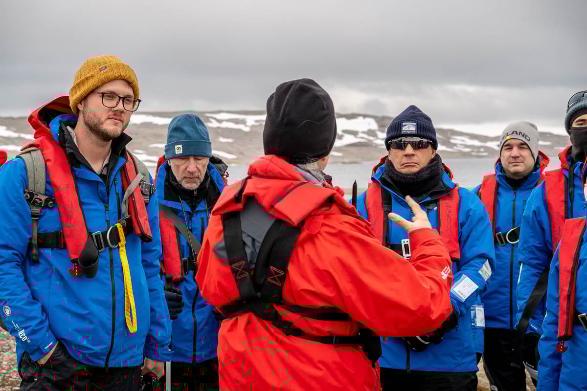 Passengers watching an expedition guide on Svalbard, Norway