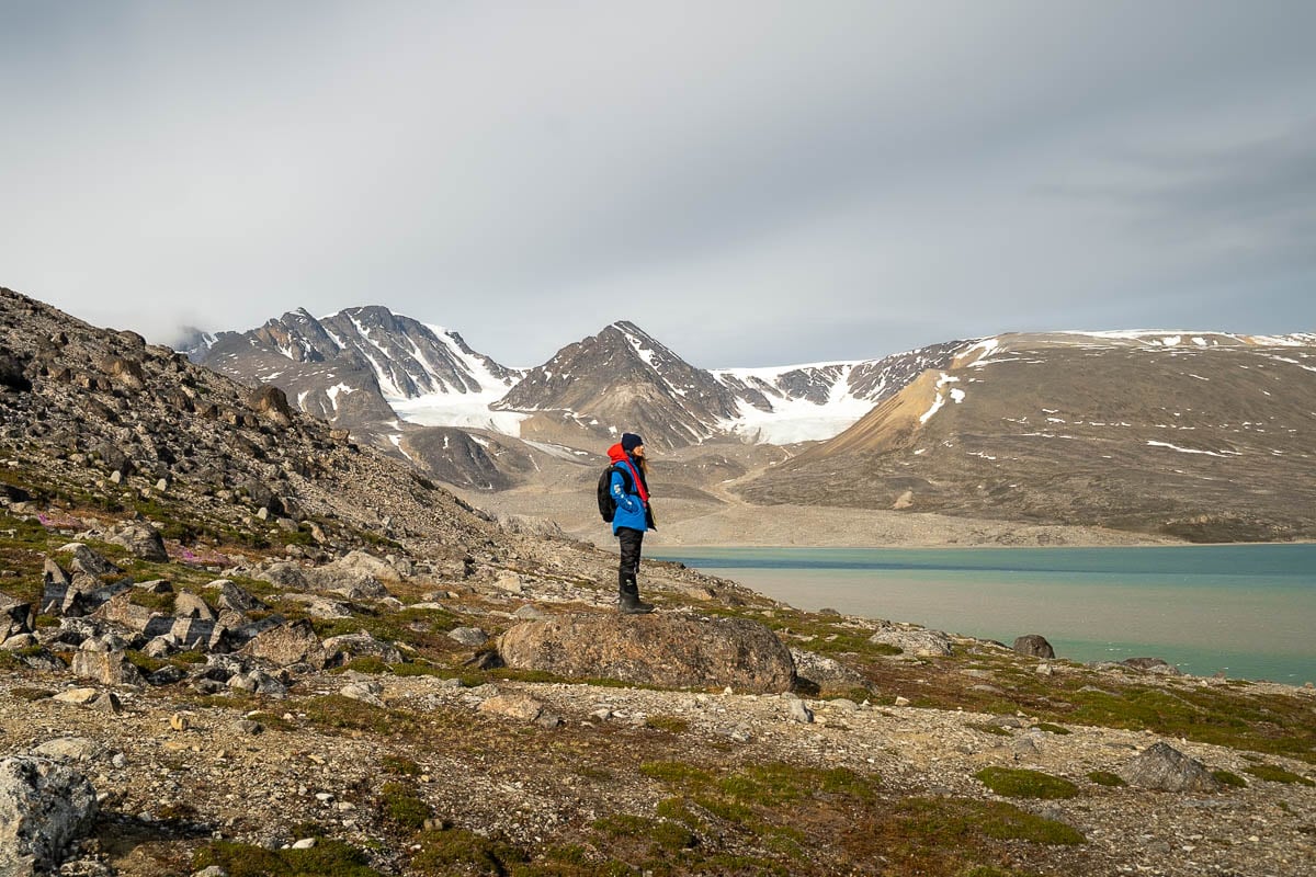 Woman standing on a rock in a fjord in Svalbard, Norway