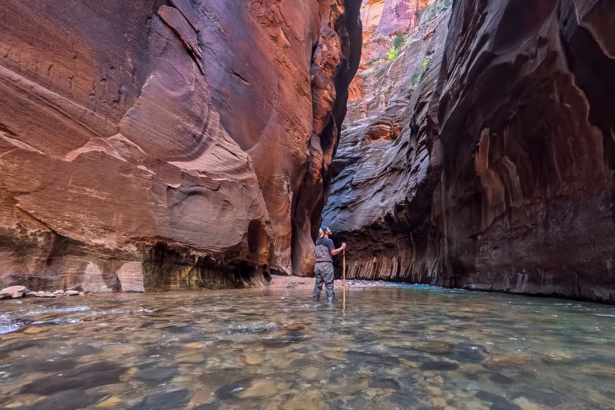 Man standing in the Virgin River along The Narrows Trail in Zion National Park