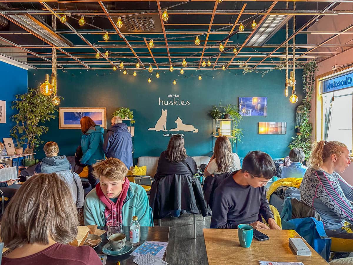 People sitting at tables in Cafe Huskies in Longyearbyen, Svalbard