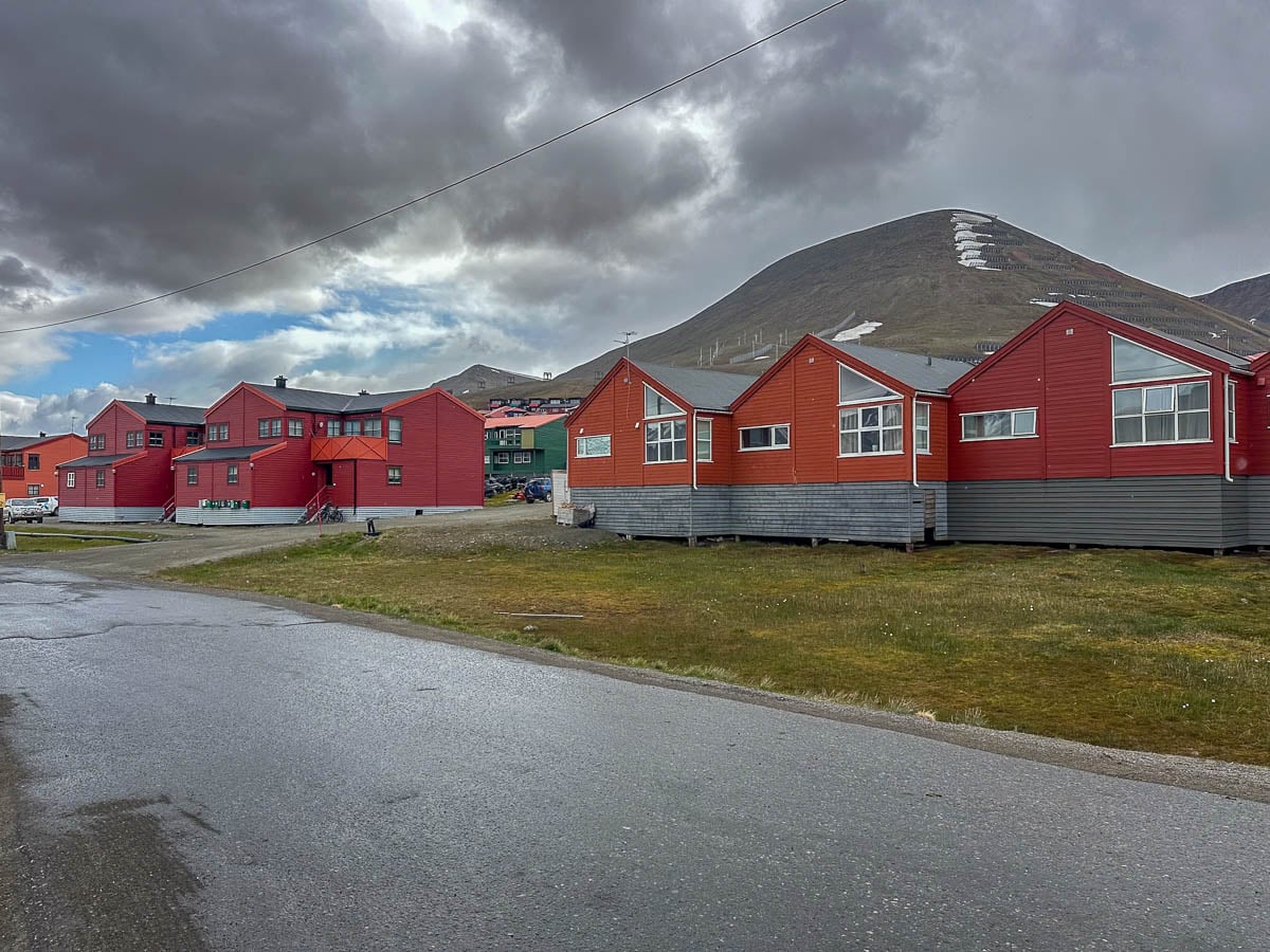 Red buildings in front of mountains in Longyearbyen, Norway