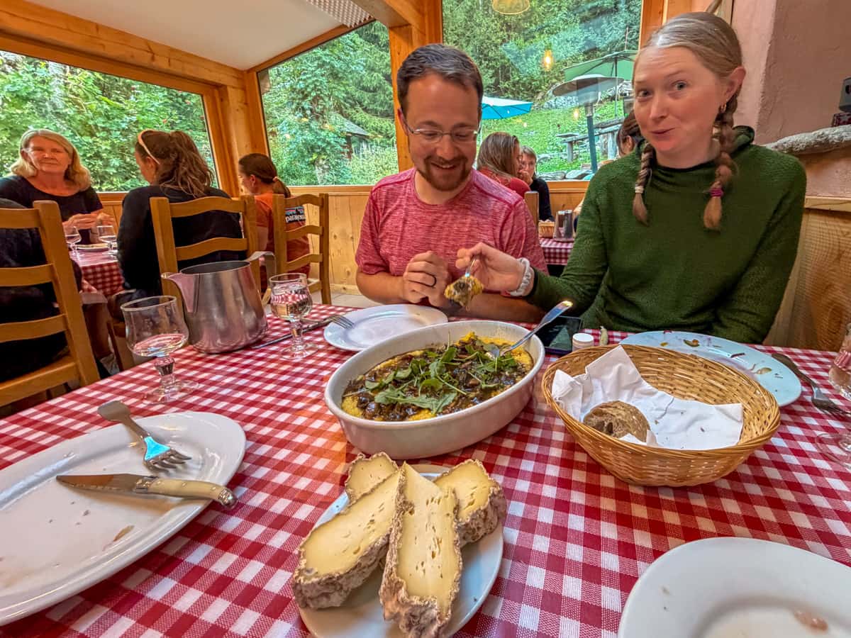 Couple eating from mushroom polenta at the Gîte Le Moulin in Montroc, France
