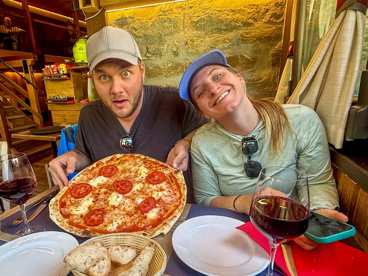 Smiling couple at a pizzeria in Courmayeur, Italy along the Tour du Mont Blanc