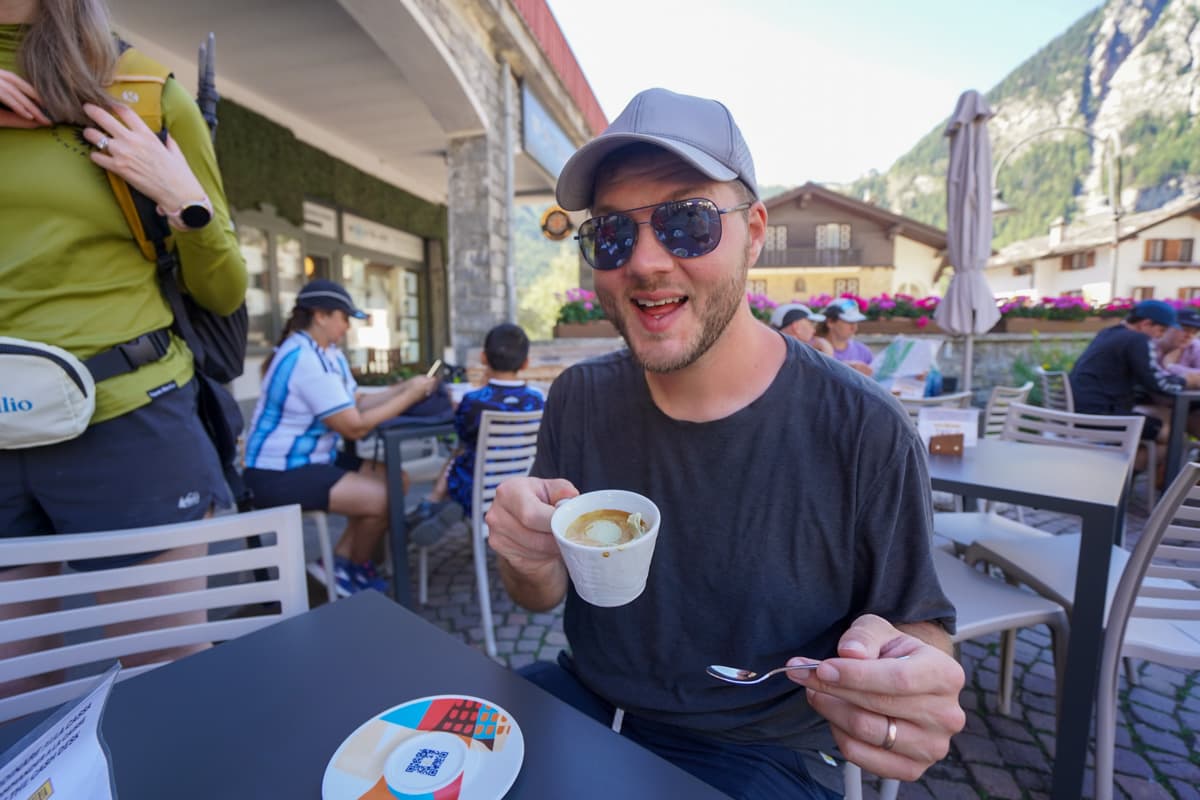 Smiling man holding an affogato in Courmayeur, Italy