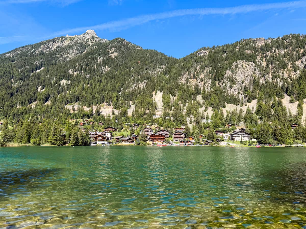 Swiss chalets lining the Lac de Champex in Champex-Lac, Switzerland along the Tour du Mont Blanc