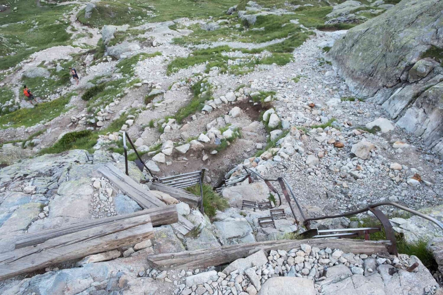 Metal ladders leading up a stone wall in the French Alps along the Tour du Mont Blanc