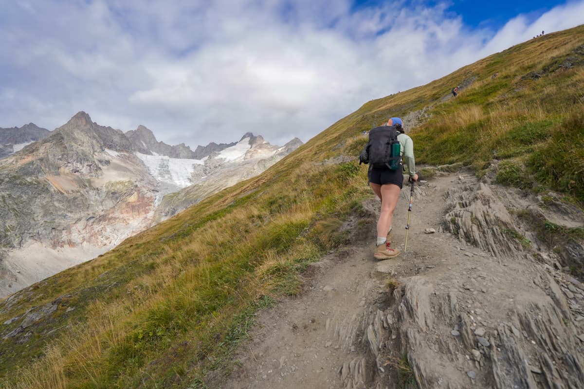 Woman hiking up to the Grand Col Ferret, Italy along the Tour du Mont Blanc