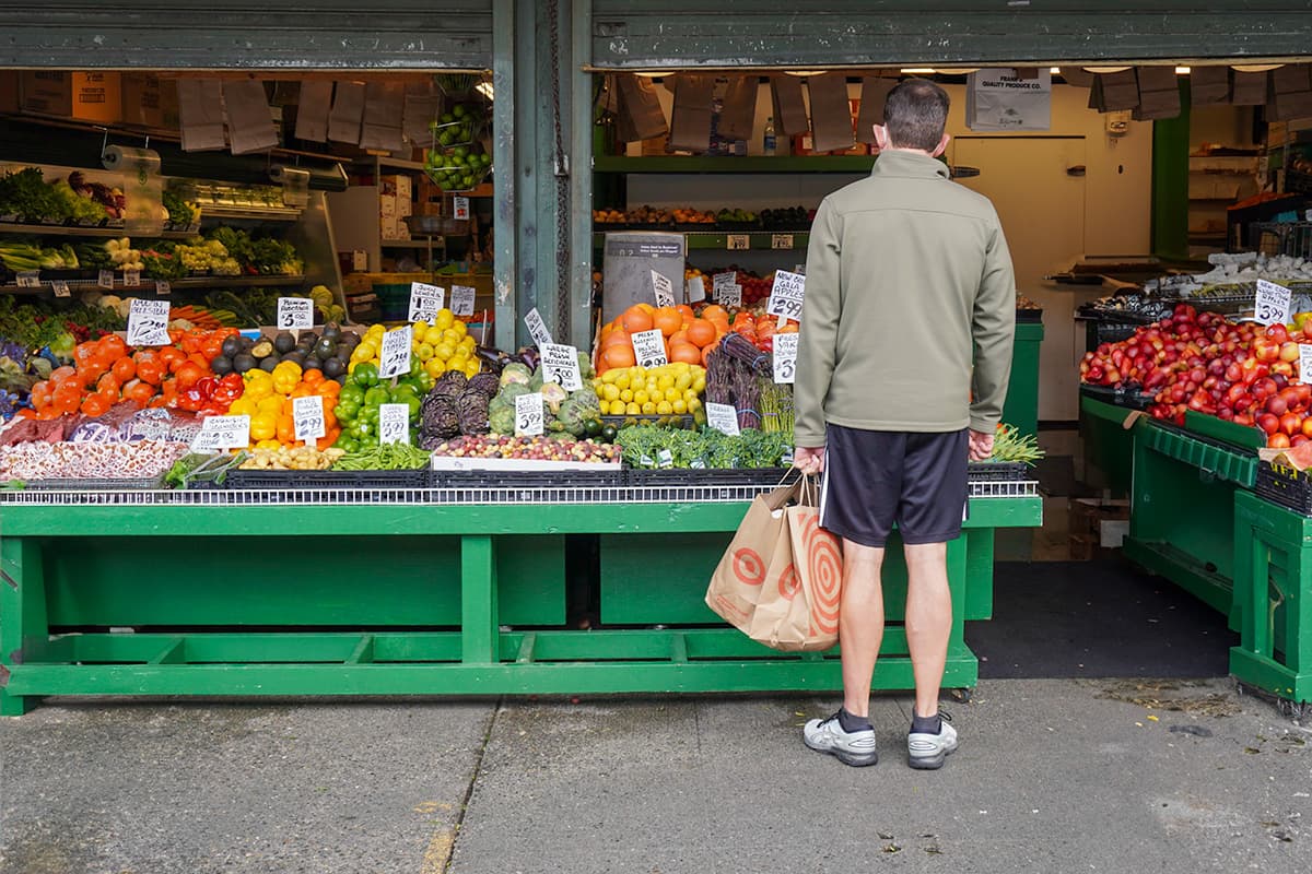 Man shopping for fruit at a stall at Pike Place Market in Seattle, Washington